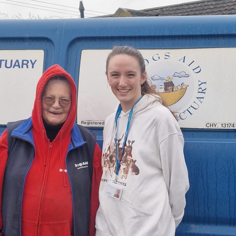 a woman and a young woman standing in front of a blue van. 3Q Recruitment Office Team Visit to Dogs Aid.