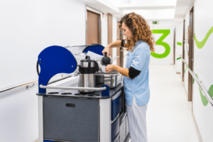 Catering Assistant, 3Q Temp pouring tea in hospital ward corridor