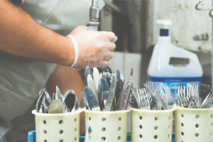 Kitchen Porter Agency Worker holding a tool in their hand. 3Q Recruitment