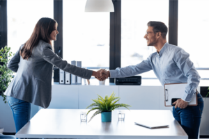 a man and woman shaking hands. 3Q Recruitment, Recruiter and candidate shaking hands at interview meeting