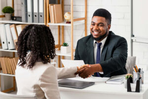 Business Man and Women shaking hands at interview, 3Q Recruitment. Activities Coordinator
