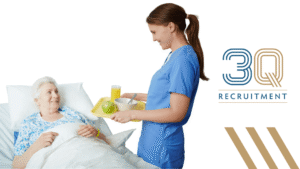 Ward Catering Assistant delivering meal trays to patients in a Dublin healthcare ward